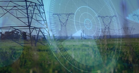 Displaying steel lattice transmission towers spanning grass field, overlaying circular digital HUD