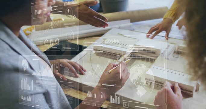 Team in business wear sketching building model in studio, with blueprints, pencils and data overlay