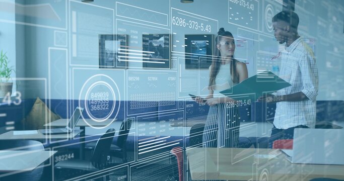 Discussing two coworkers analyzing AR data interface in modern office, with laptop and tablet