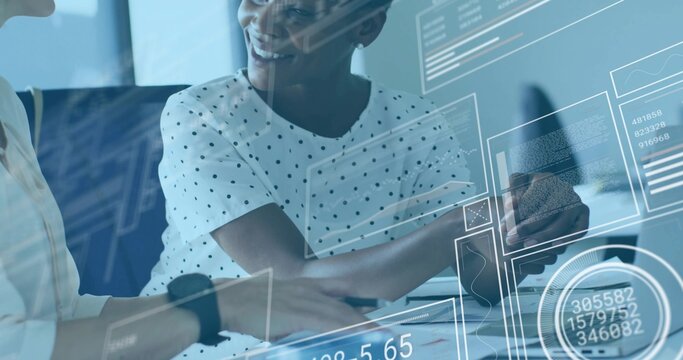 Colleagues in blouses analyzing printed documents and charts in meeting room, with coffee and phone - Powered by Adobe