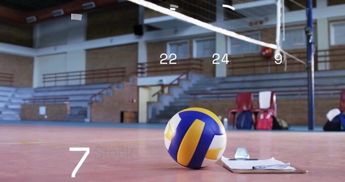 Fototapeta Lying volleyball beside clipboard and pen on gymnasium court, with net posts and red chairs