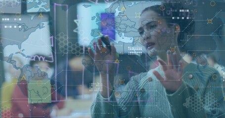 Manipulating holographic world map data charts on transparent display panel in office, with stylus