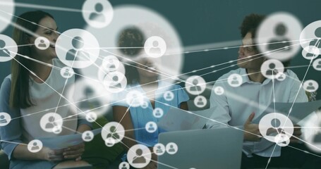 Collaborating professionals reviewing network overlay in office lounge, with laptop and documents