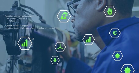 Inspecting hoses, technician wearing work jacket and glasses in factory, with code and data icons