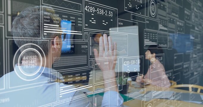 Collaborating professionals interacting with interface panel in conference room, with graphs, codes