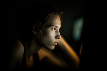 teenager deeply engaged in online game on computer demonstrating clear communication with friends