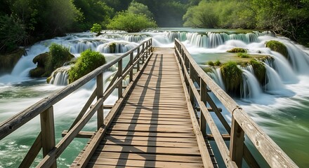 Wooden Bridge Over Cascading Waterfalls in Lush Green Forest.