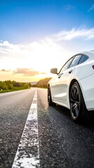 Fototapeta premium White car on a road at sunset