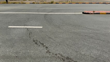 Curved empty city street with yellow lane markings