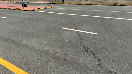 Curved empty city street with yellow lane markings