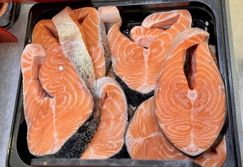 Atlantic salmon steaks from frozen raw materials on a substrate on a showcase for sale