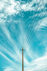 Obraz premium Telephone poles and wires under the blue sky