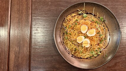 Salad with pork and potato pie in a brown plate on the table in the restaurant. Delicious food