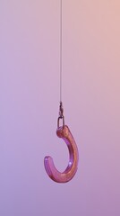 Pink metal hook suspended in front of a gradient background