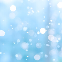 Soft blue bokeh and falling snowflakes for a winter ambiance