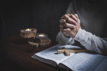 Religious concepts, Woman praying with his hands on a bible.