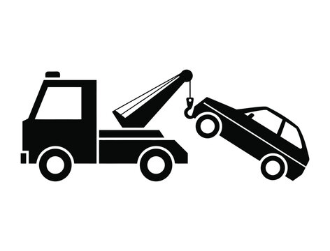 Fototapeta Silhouette of a tow truck lifting a broken down car with its crane