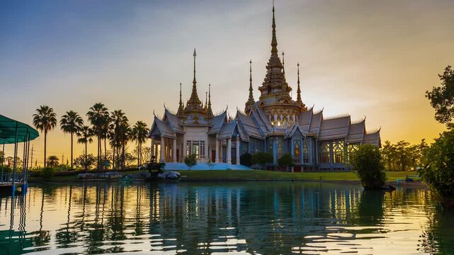 Timelapse of Wat Non Kum or Wat Luang Pho To in Sikhio District, Nakhon Ratchasima, Korat, Thailand is a symbolic place of temples in Thailand. At sunset, there is a reflection in the water.