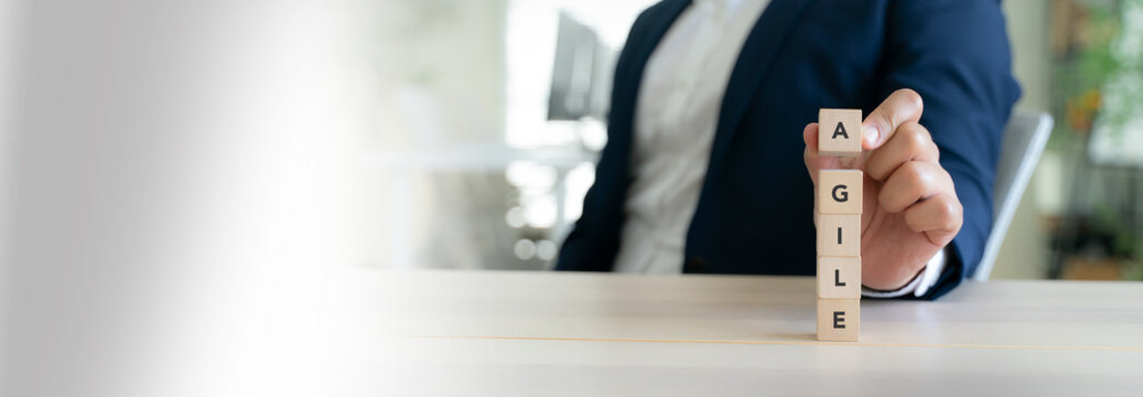 Agile Business Concept. Wooden blocks stacked vertically to spell word "AGILE" ,representing agility in business and project management methodologies. Adaptability, innovation, modern work practices.