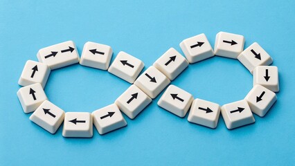 Naklejka premium Infinity symbol made of white keyboard keys with directional arrows on blue background – Conceptual metaphor for continuous motion, digital flow, and limitless potential in technology and design
