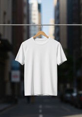 Blank white t-shirt mockup hanging on a wooden hanger against a blurred urban city street