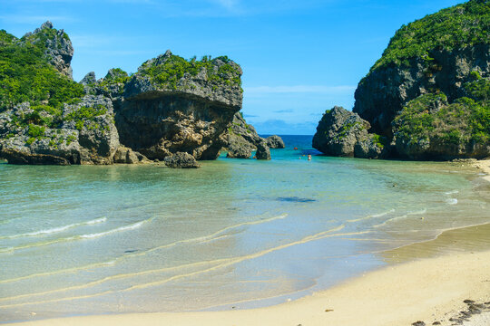 A clean small beach surrounded by natural reefs