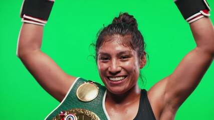 A woman boxer, triumphant and sweaty, holds up her arms in victory against a green screen. - Powered by Adobe
