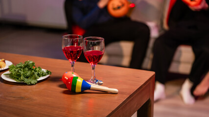 A lively Halloween party table featuring glowing pumpkin decor, festive food, and friends in costumes. celebration, creativity, and the joyful spirit of sharing spooky moments together.