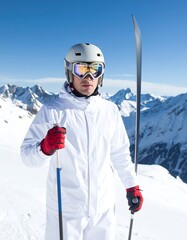 A skier, outfitted in a pristine white ski suit, stands poised on a snowy mountaintop, bathed in bright sunlight.