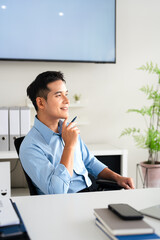 Naklejka premium Happy smiling professional business man company employee, young male worker manager, businessman working on laptop computer technology looking aside at copy space working in office.