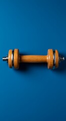 Wooden Dumbbell on Blue Background