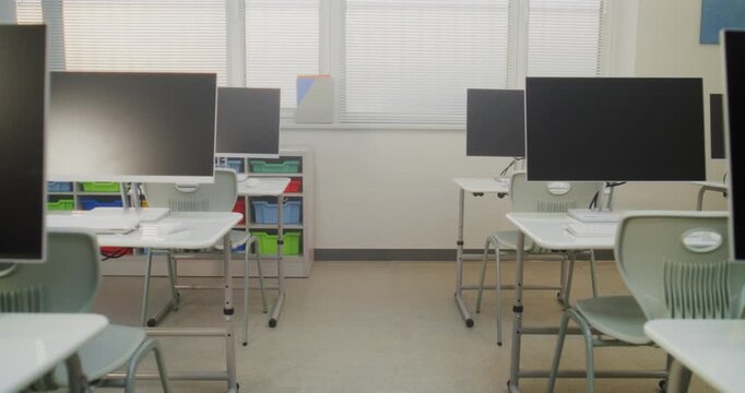 High-Tech School Computer Lab with Minimalist Furniture and PC Monitors. Modern Classroom Setup Ready for Students to Practice Coding, Design, STEM Projects and Innovative Digital Learning. Dolly Shot