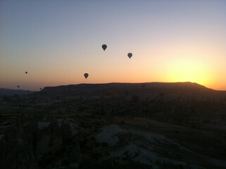 Hot Air Balloons Floating Over Rock Formations at Dawn in Cappadocia, Turkey