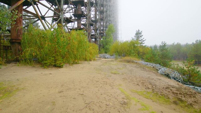 Panoramic view of the massive Duga 1 Over the Horizon Radar system, an abandoned Soviet military relic, amidst overgrown nature in the Chernobyl Exclusion Zone, Ukraine.