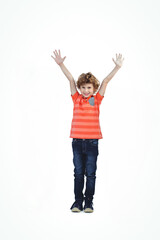 Joyful child in striped shirt raising arms, smiling with excitement in studio