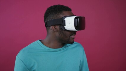 Close up view of handsome man putting on the glasses of virtual reality, happily looking around, evading, laughing, he takes it off and cheerfully smiles straight to camera. Devices, gadgets. Male