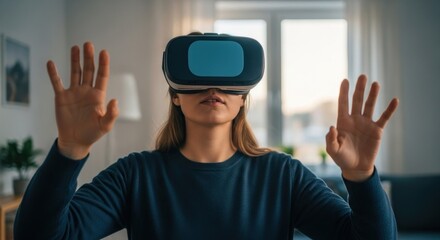 Naklejka premium Woman with VR headset, hands up, immersed in virtual reality in a living room