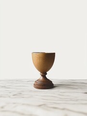 Wooden goblet on a marble surface, against a white backdrop