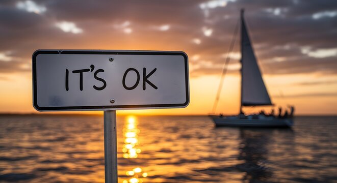 It's OK Sign with Sailboat at Sunset