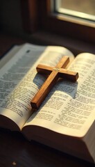 Obraz premium A cross rests on an open Bible, surrounded by soft, natural light, symbolizing faith, hope, and divine love within a Christian context , blessing, worship