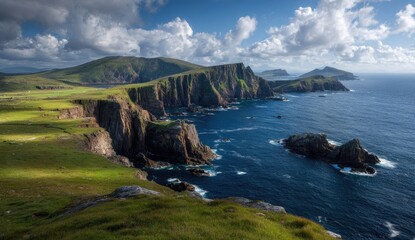 Obraz premium Dramatic coastal cliffs meet a vibrant blue ocean under a partly cloudy sky