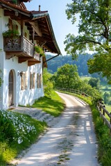 Fototapeta premium Gravel road leading to a traditional bavarian house in springtime