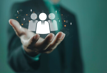 Businessman holding human resource icons with global network connections, symbolizing HR management, recruitment, leadership, workforce, corporate teamwork, business strategy, organizational growth