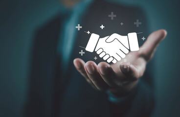Businessman holding handshake icon symbolizing partnership, trust, business deal, collaboration,...