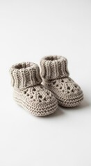 Hand Knitted Beige Baby Booties on White Background Studio Shot