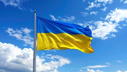 Ukrainian flag waving in the wind against blue sky.