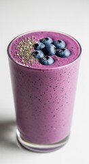 Blueberry Smoothie in Tall Glass on White Background with Chia Seeds