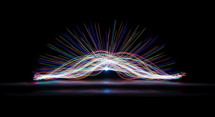 Abstract Multicolored Light Trails Forming A Symmetrical Arc Against Black Background