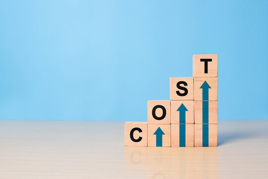 Cost increase and inflation concept. The word cost on wooden cubes with arrows going up.