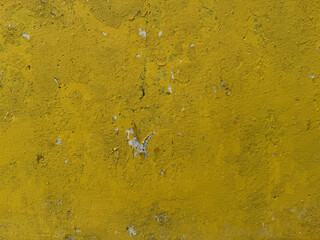 Aged yellow concrete wall with rustic textured surface